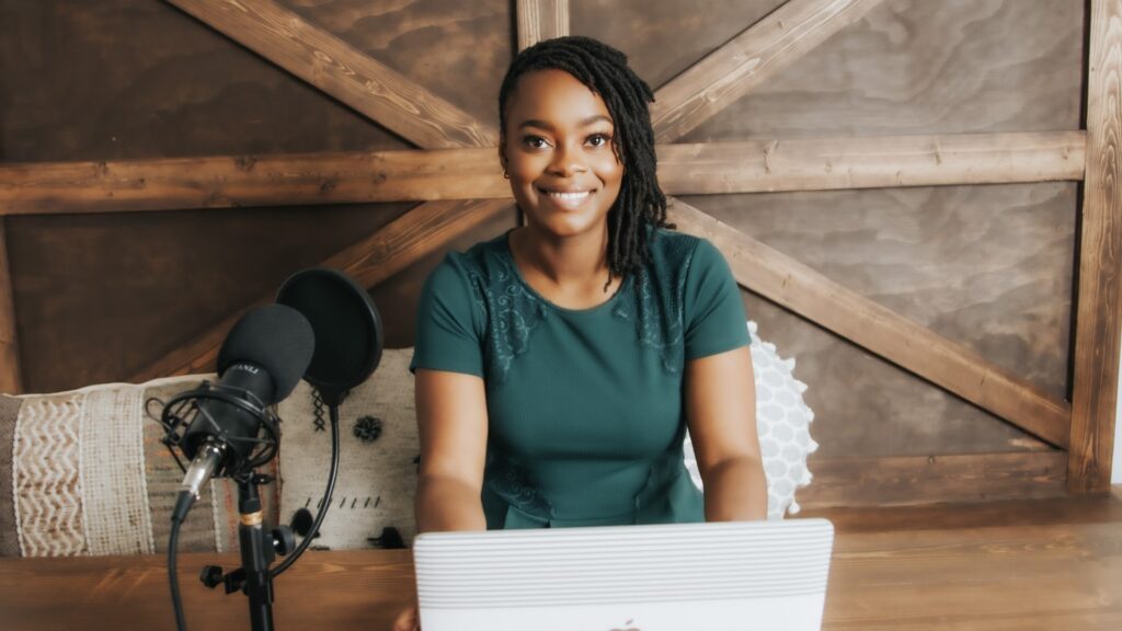 Professional Organizer Atlanta, GA Black woman, smiling in camera with a laptop, Kenika Williams
